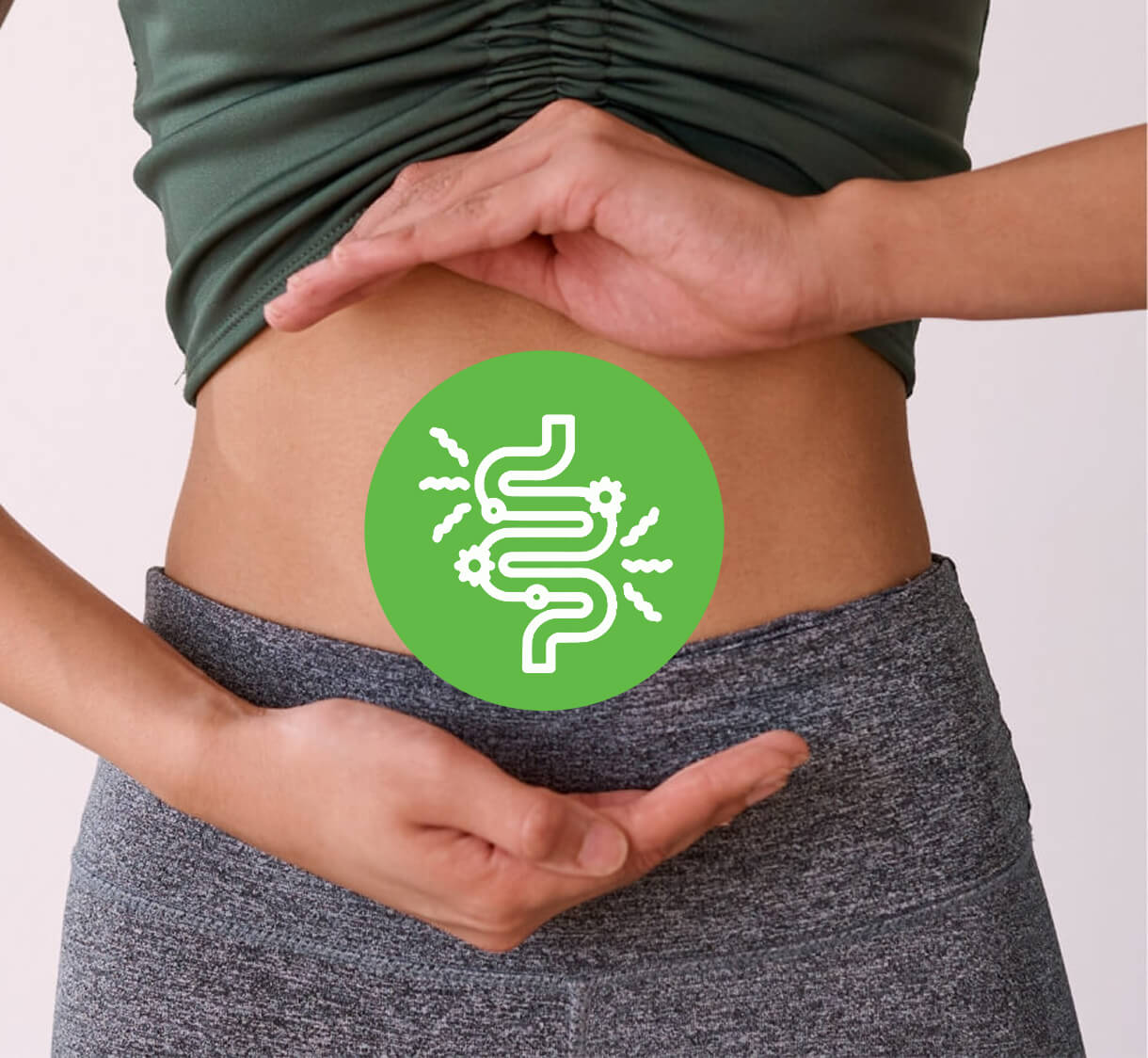 Woman holding her hands around her stomach with a green digestive-system icon