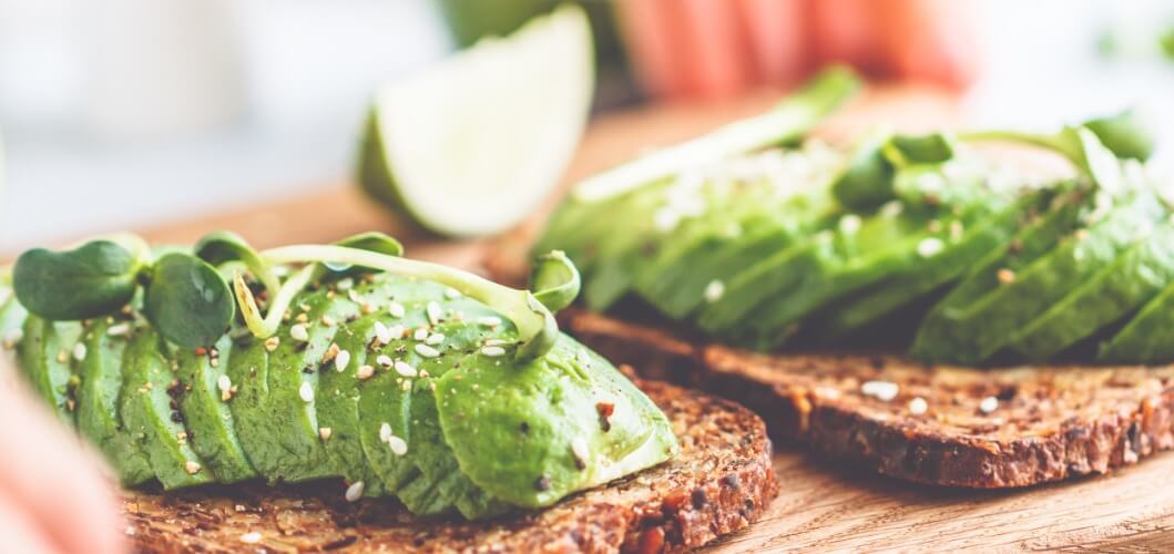 avocado sliceed on bread sliced avocado spread on sandwiches