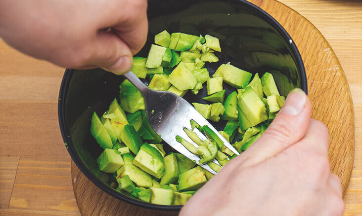 Mashed Avocados in a bowl ready to be made into guacamole
