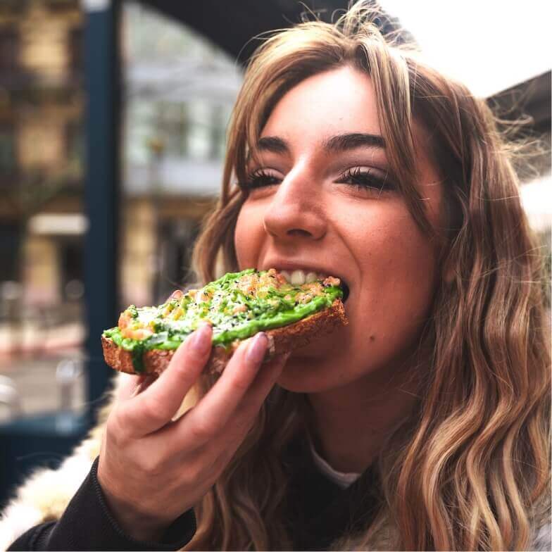 woman eating avocado toast