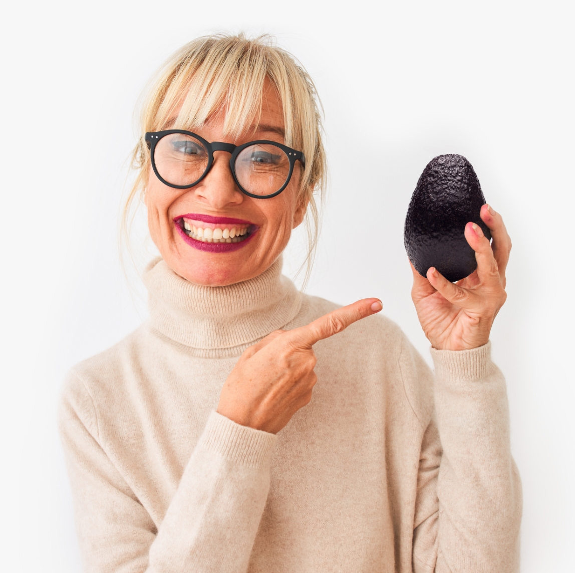 woman holding avocado